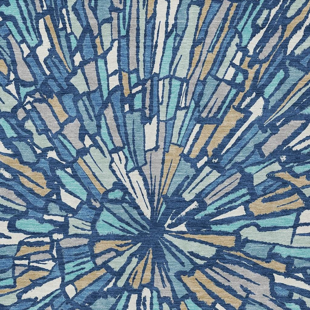 Abstract area rug with navy, teal, and cream radial rays and splatter accents.