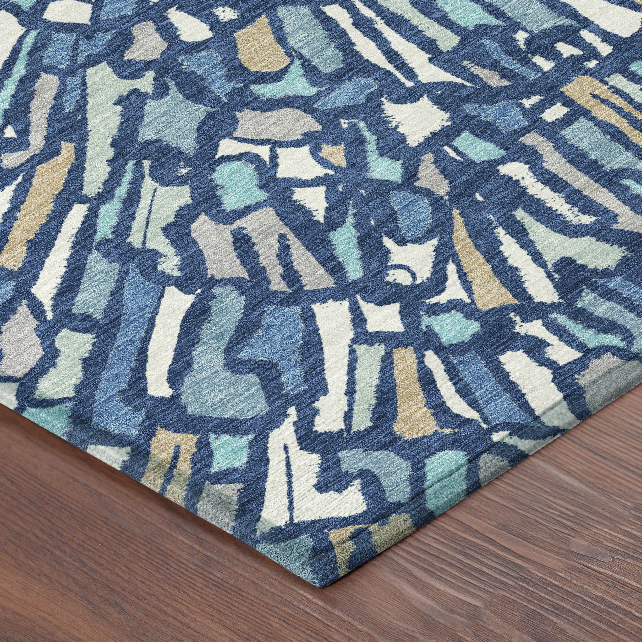 Abstract area rug with navy, teal, and cream burst pattern; low pile.