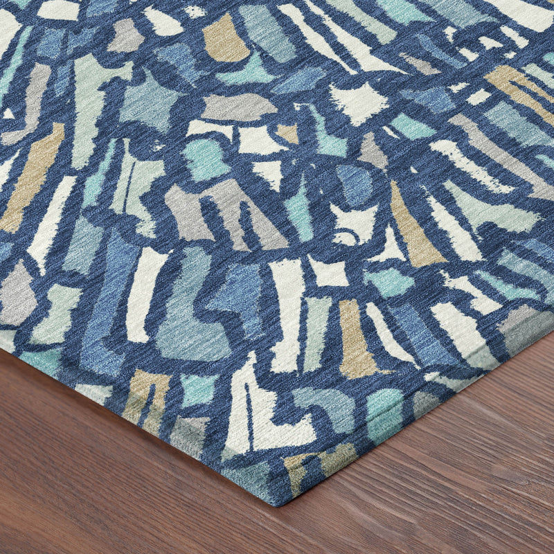 Abstract area rug with navy, teal, and cream burst pattern; low pile.