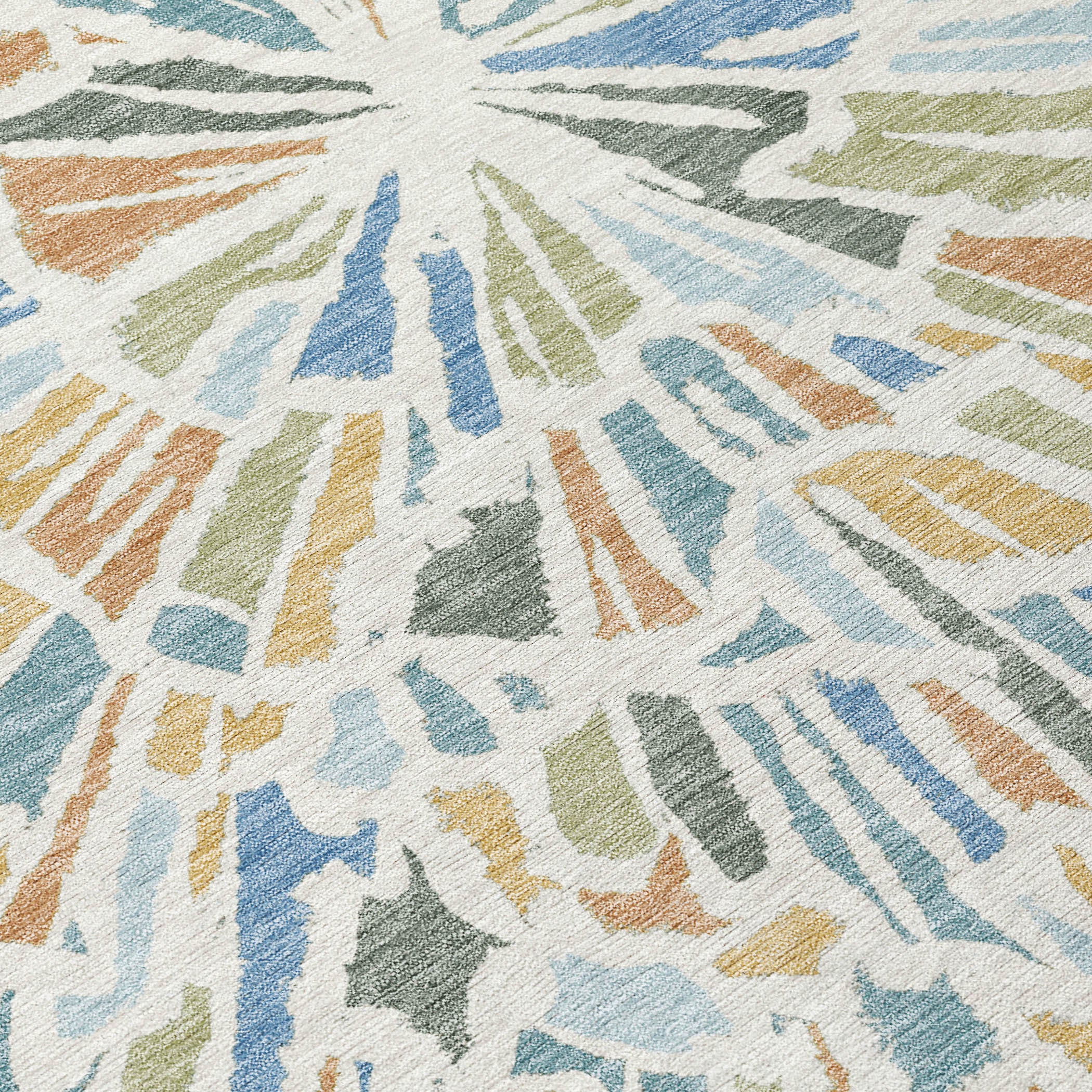 Close-up abstract area rug texture with multicolor radial strokes in blue, beige, and green