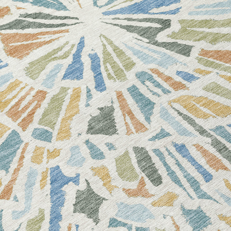 Close-up abstract area rug texture with multicolor radial strokes in blue, beige, and green