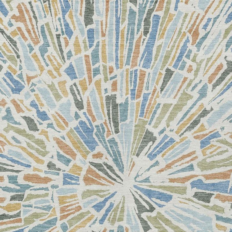 Light blue abstract area rug with beige and tan radial burst design, flat-woven look