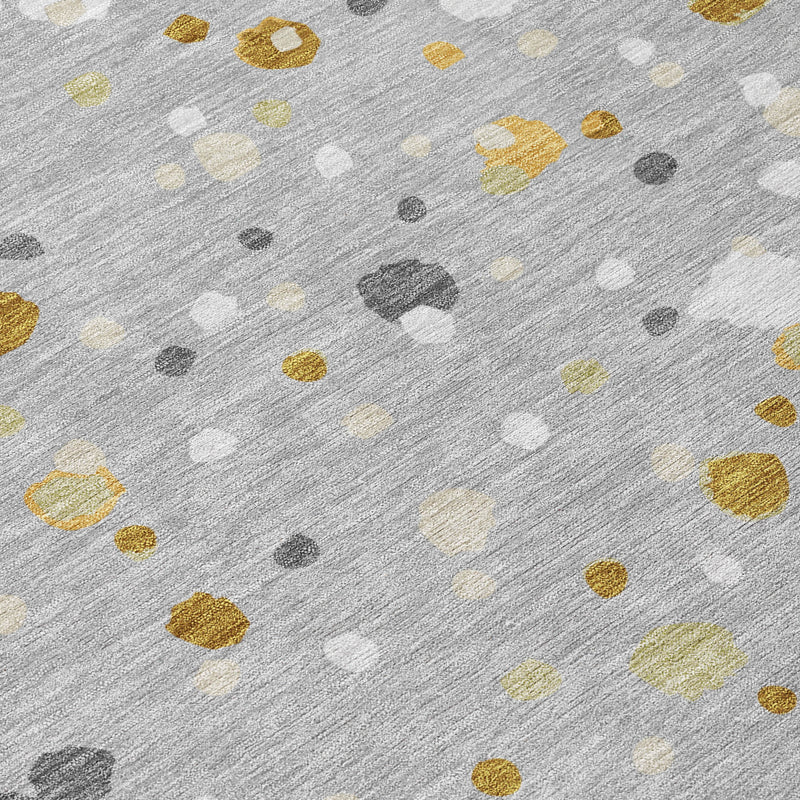 Close-up gray area rug with textured speckles in gold, cream, white, and charcoal