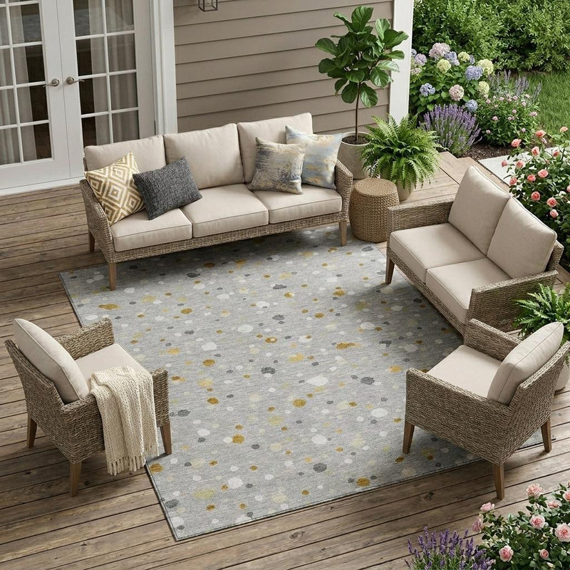 Gray geometric speckled area rug with gold and white dot pattern on the floor