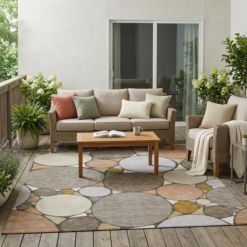 Indoor outdoor area rug with taupe and beige circle geometric pattern on a patio floor
