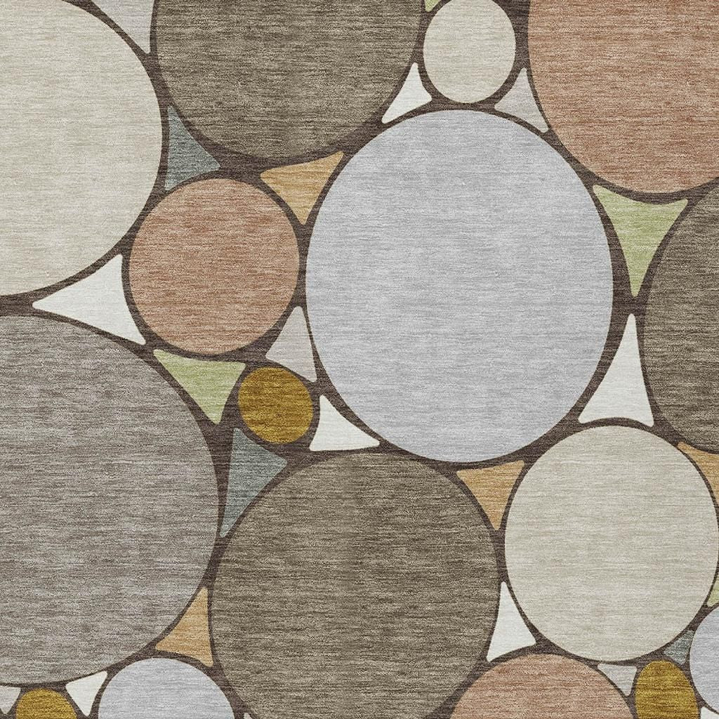 Pattern detail of geometric rug with large white and dark gray circles and gold accents