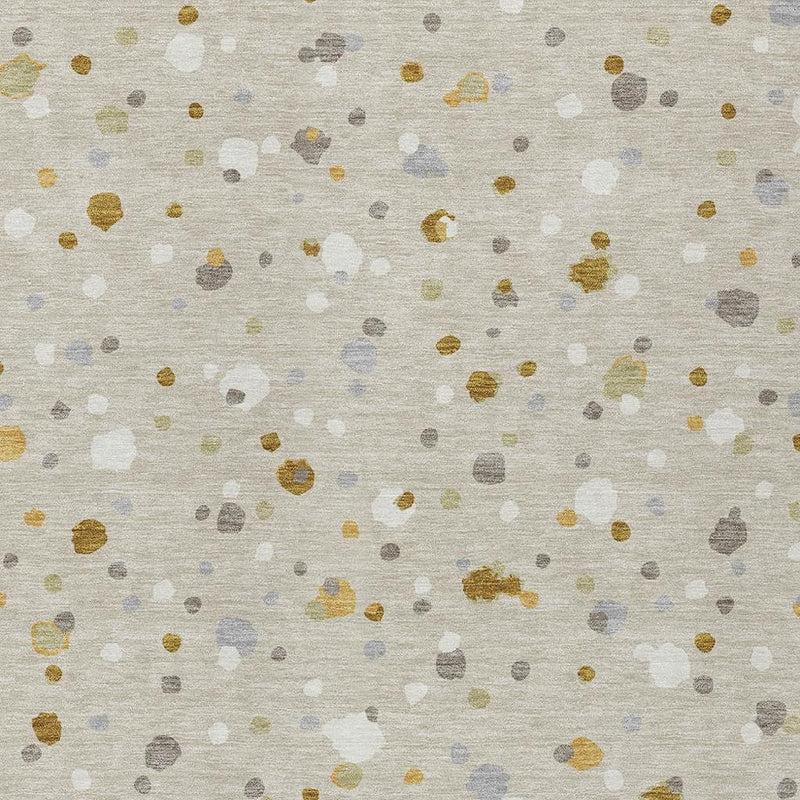 Beige geometric speckle area rug with gold, light blue, and gray dots close-up