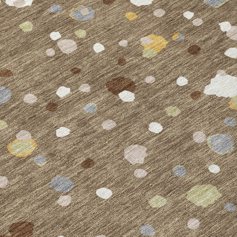 Brown area rug with scattered white oval and pastel blue speckle shapes, flat weave