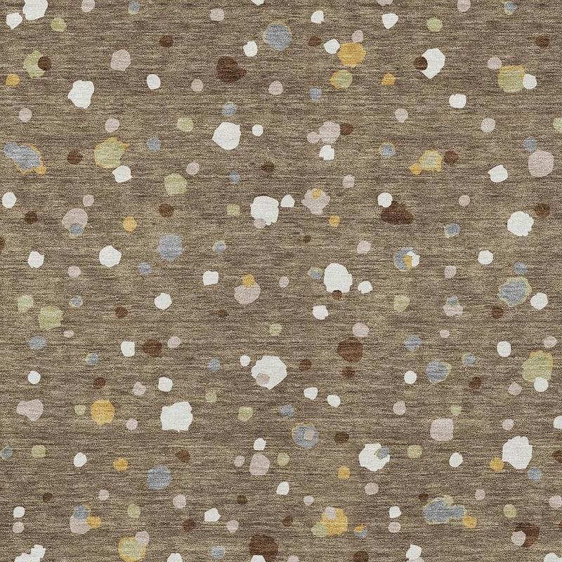 Close-up of brown flat-weave area rug with scattered white and pastel speckle shapes