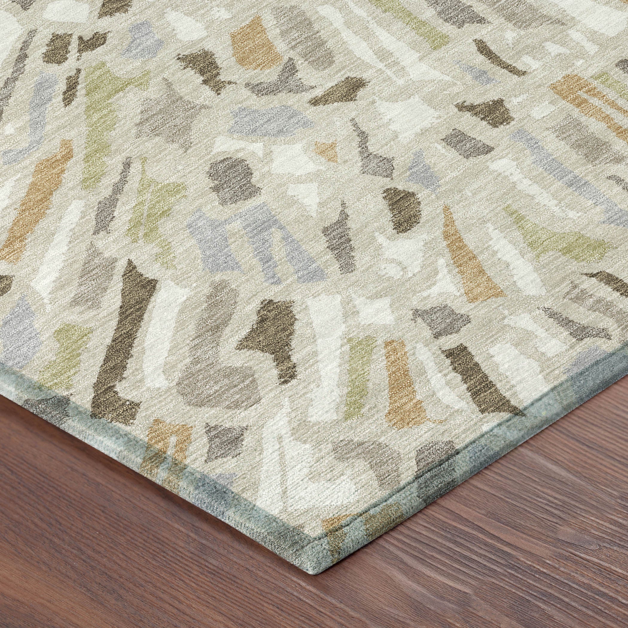 Beige, taupe, and light gray round abstract area rug, corner view
