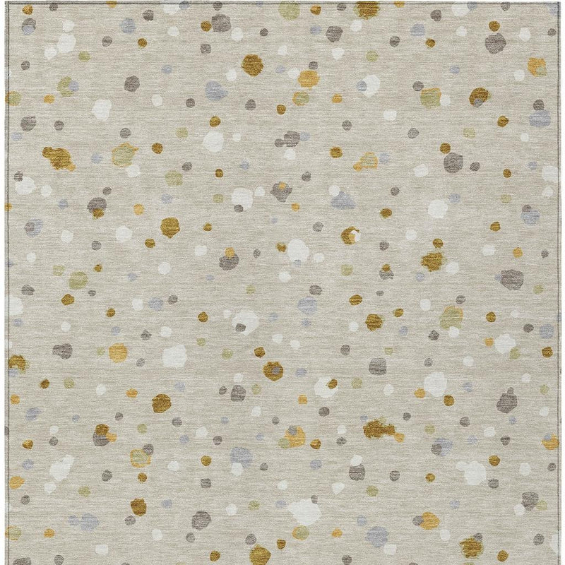 Beige area rug close-up with gold and gray speckles and pale blue shapes