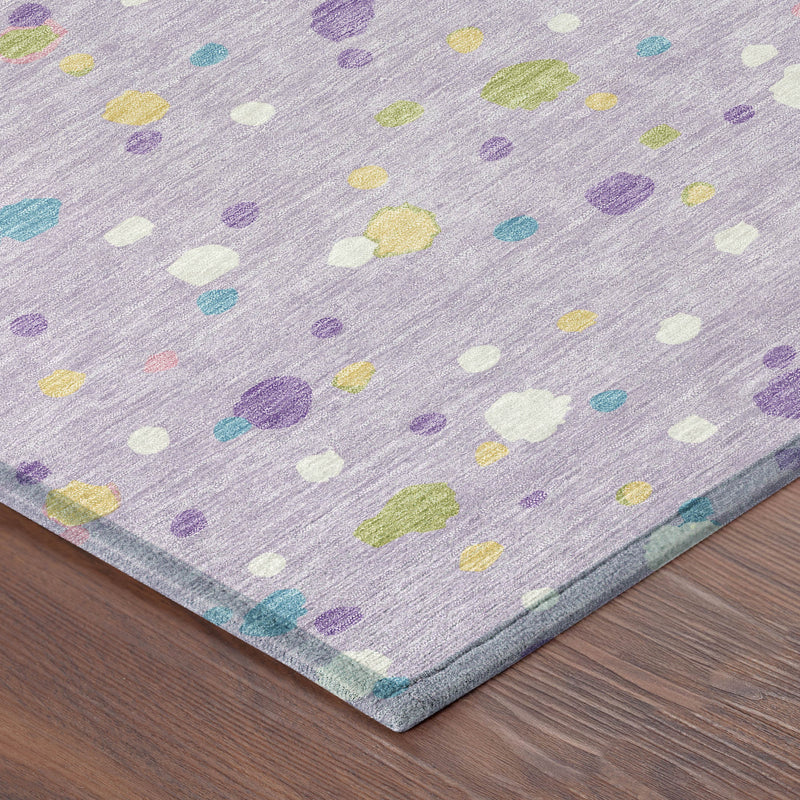 Corner view of round lavender rug showing multicolor confetti dots and flat edge