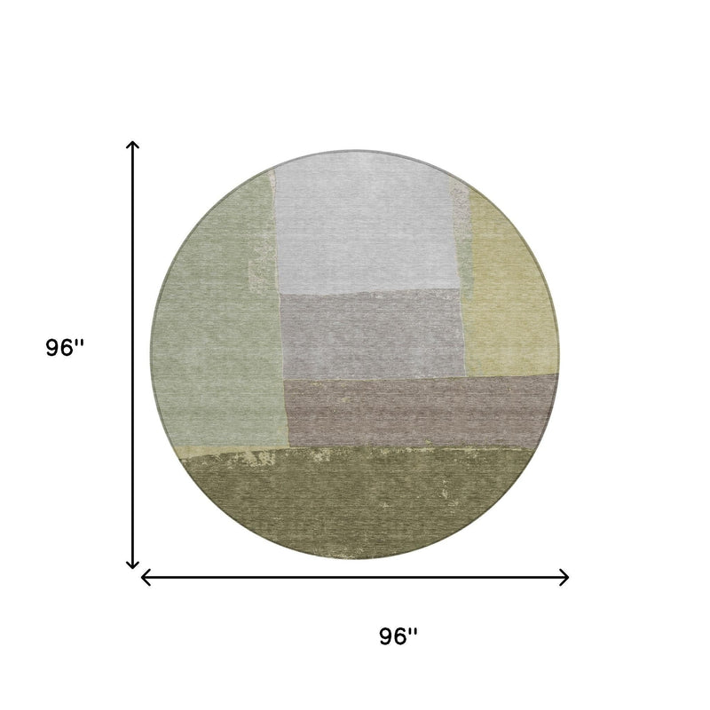 Round 96-inch geometric area rug in olive and fern green patchwork blocks, washable.
