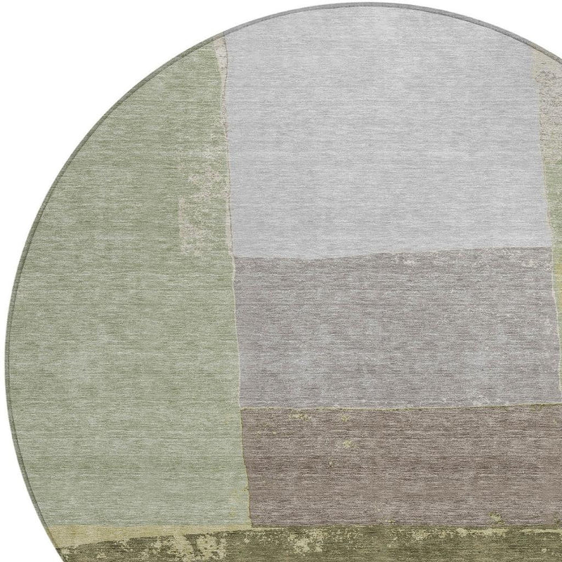 Round geometric rug with olive and fern green left section and gray-beige block pattern.