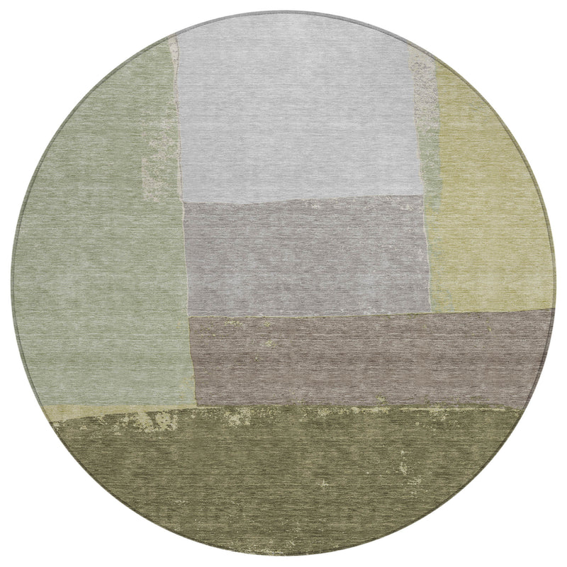 Round patchwork area rug with olive and fern green border and gray center blocks.