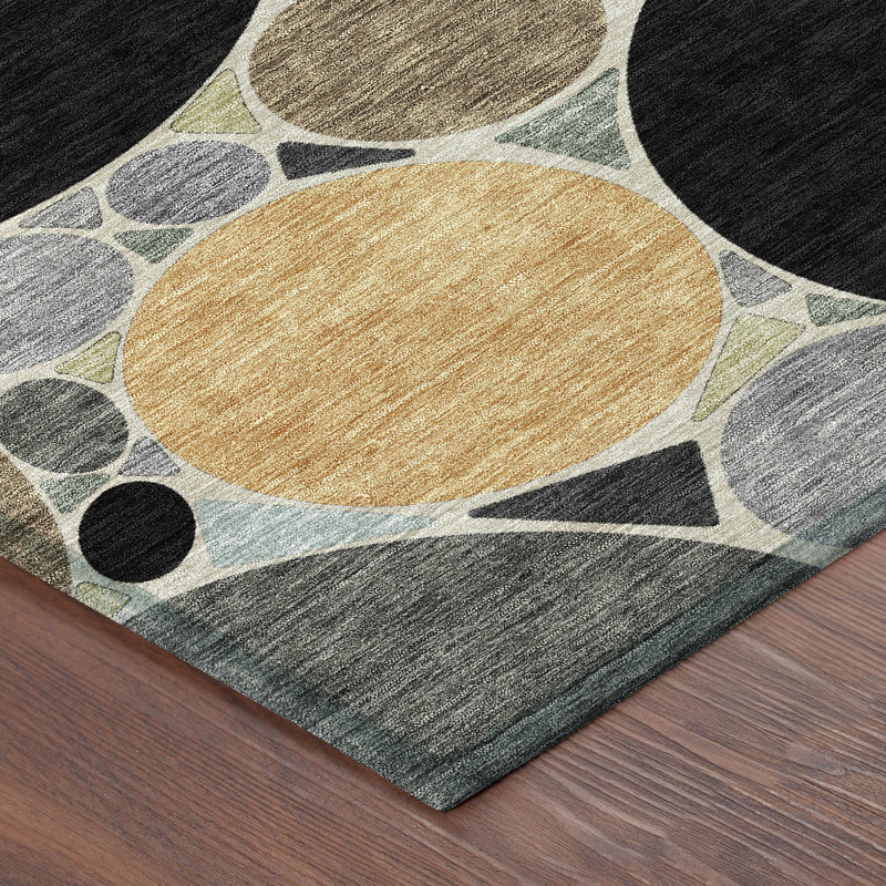 Geometric area rug corner with gray base, tan center circle and black accents