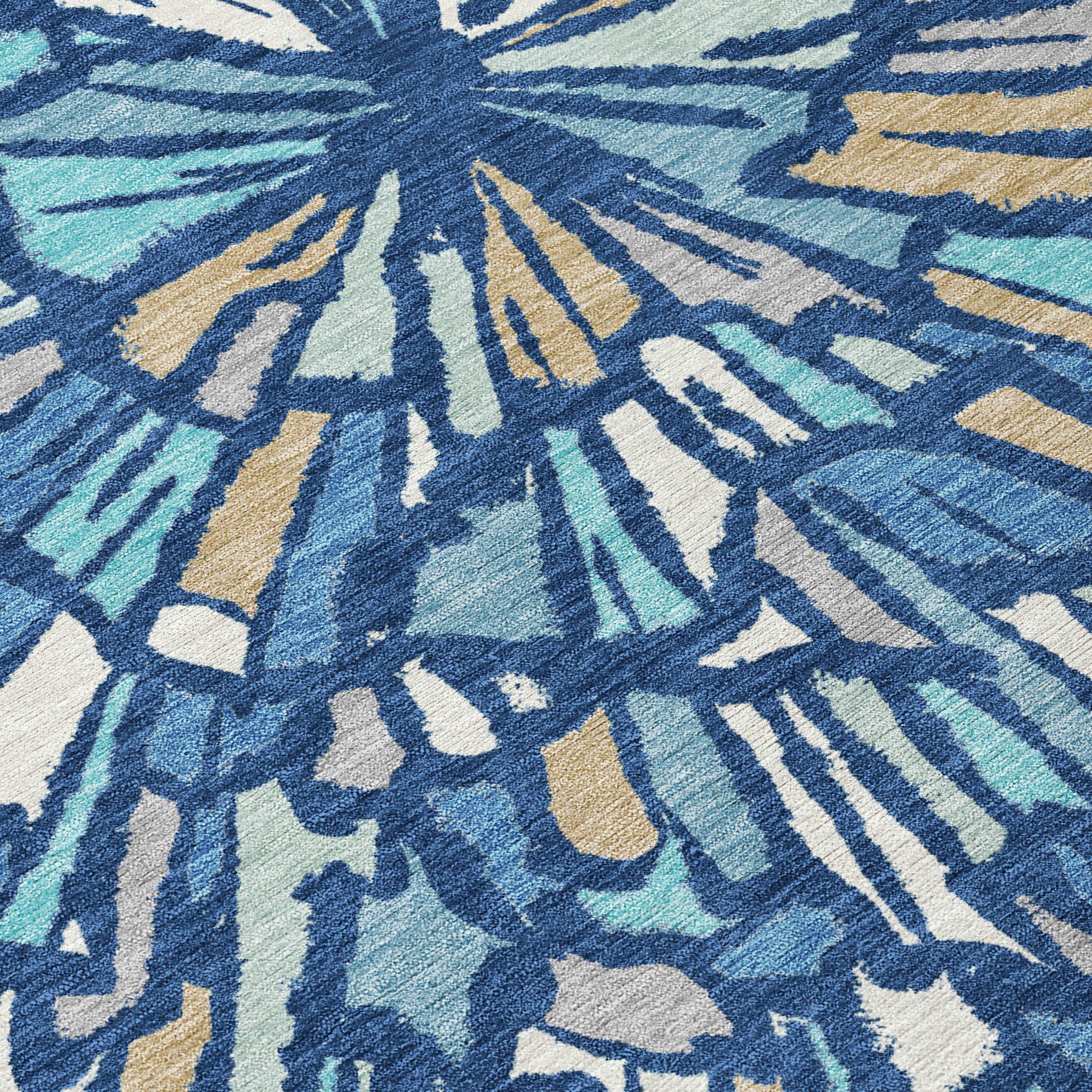 Textured close-up of abstract sunburst area rug in navy blue, teal, and cream tones