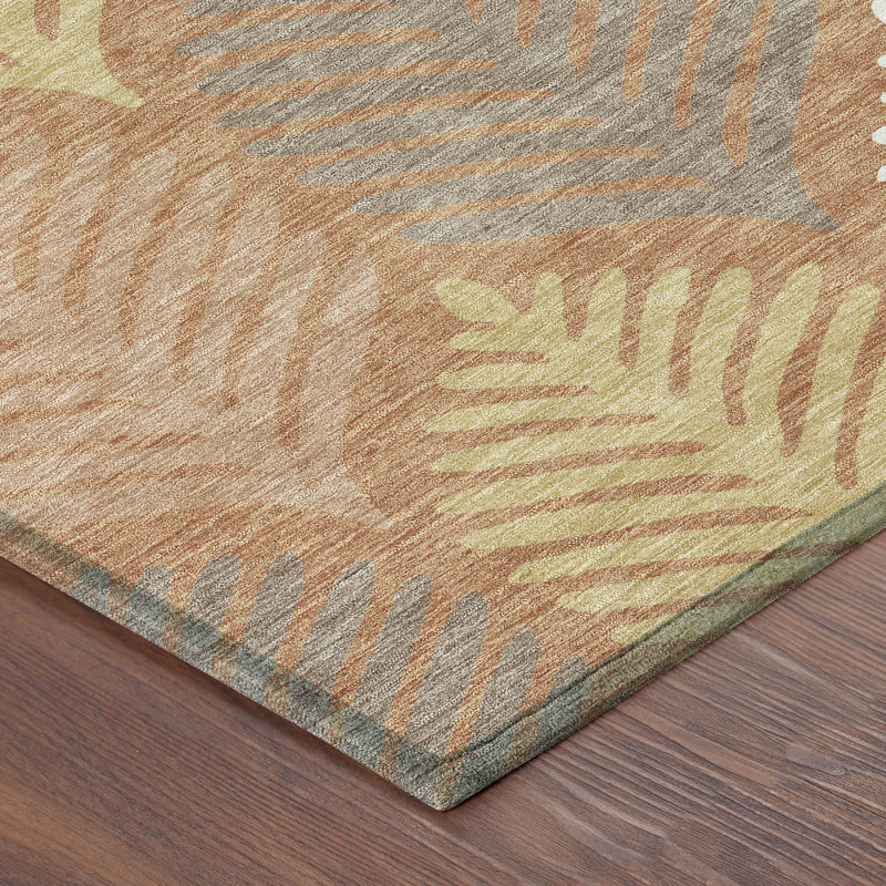 Corner of orange and copper leaf patterned rug showing flat woven texture