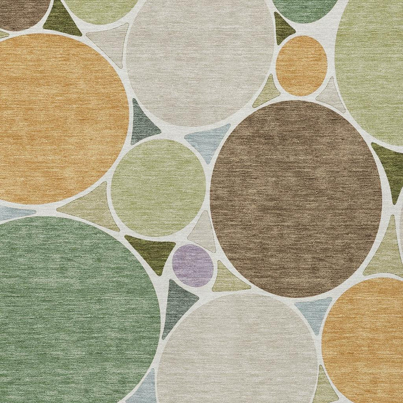 Close-up geometric area rug with large overlapping circles in green, brown, tan, and purple