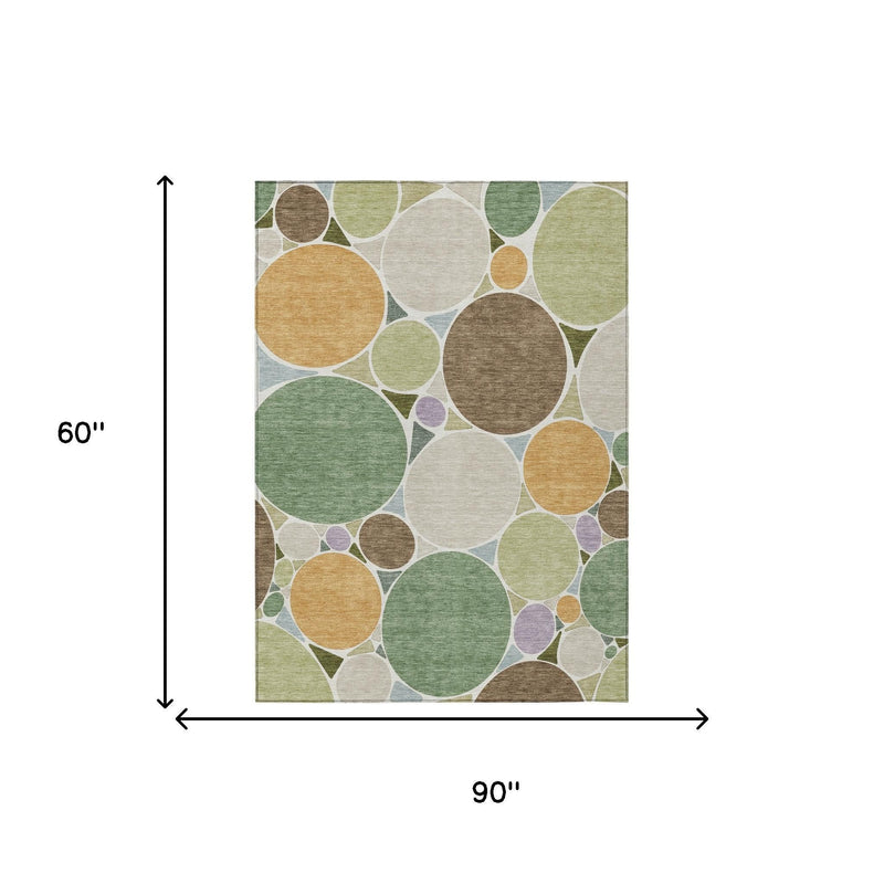 Geometric area rug, 90 in x 60 in, with green and tan overlapping circle pattern