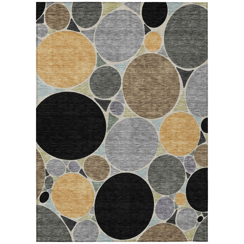Geometric area rug with black, gray, tan, and gold oval circle pattern