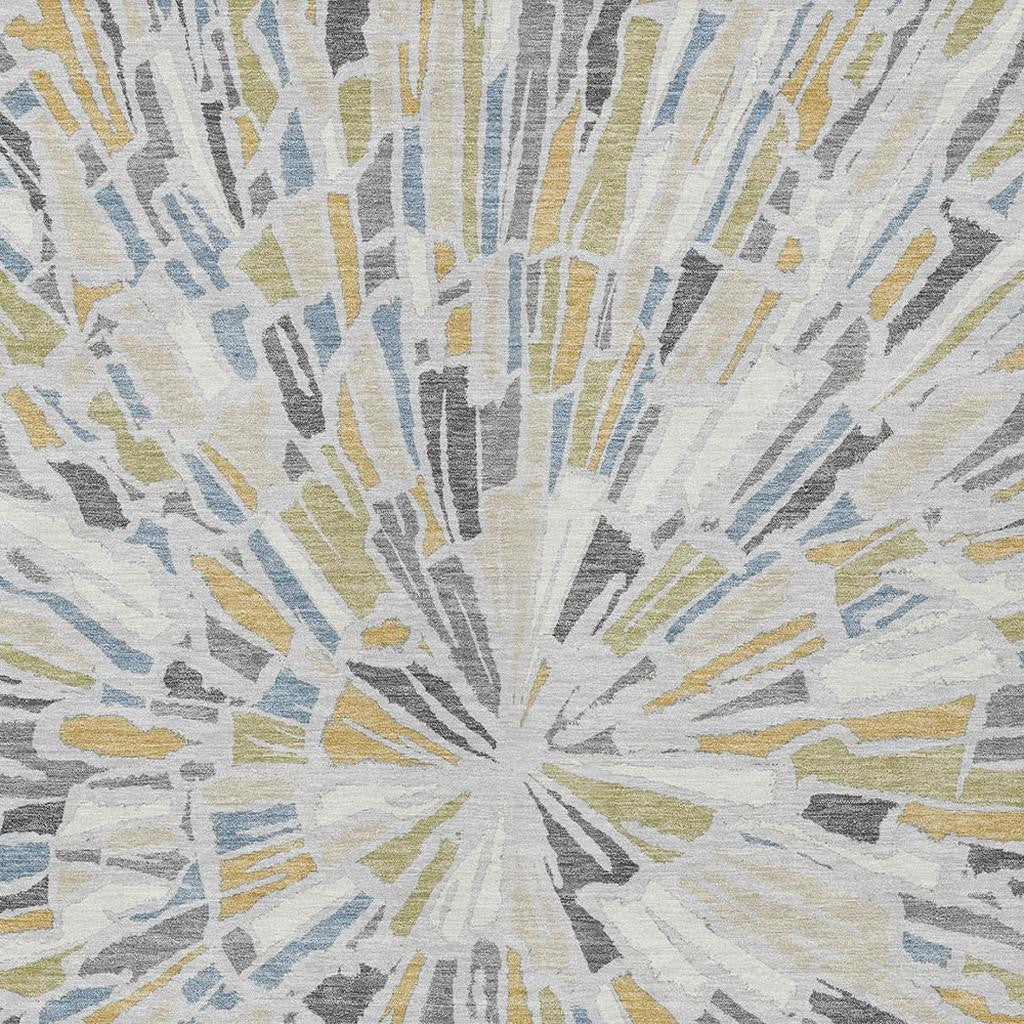 Abstract area rug rug close-up with radial sunburst lines in gray, blue, yellow, and cream.