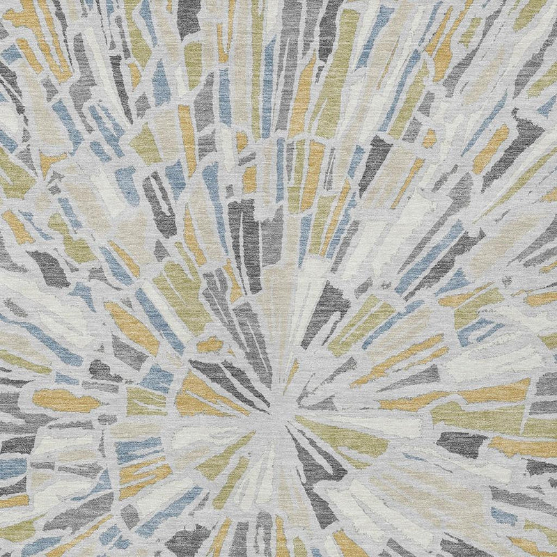 Abstract area rug rug close-up with radial sunburst lines in gray, blue, yellow, and cream.