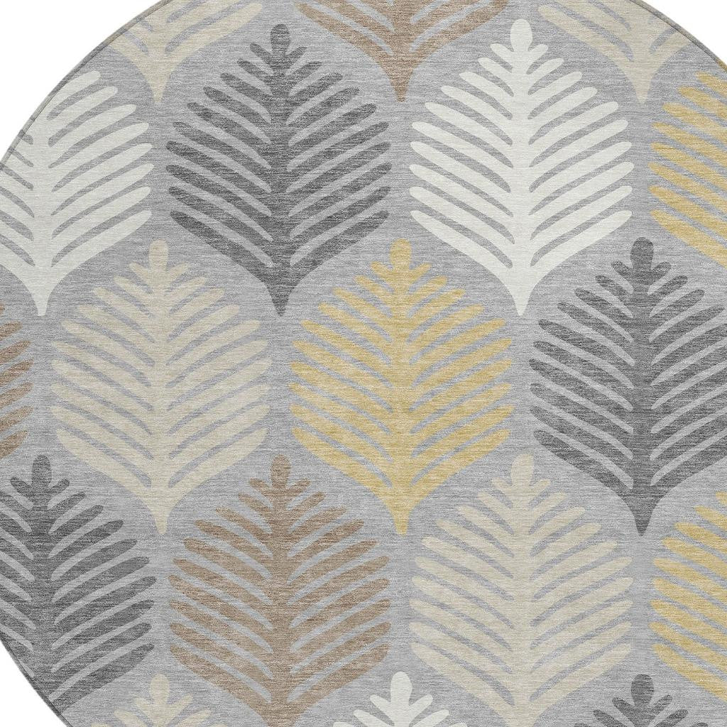 Round area rug with gray, beige, and light yellow leaf pattern, washable indoor/outdoor style.