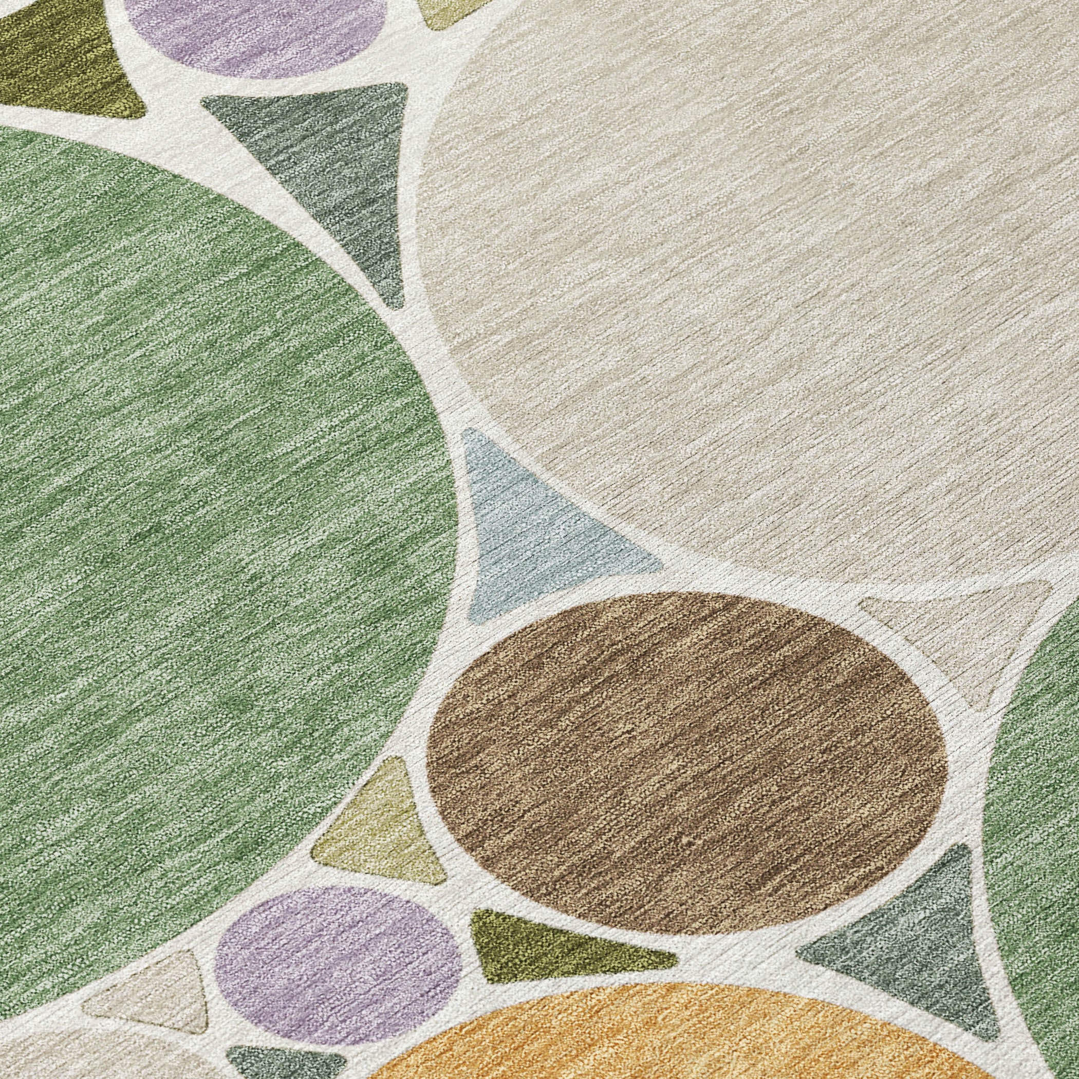 Geometric area rug with green, tan, brown and purple circle pattern on light ground