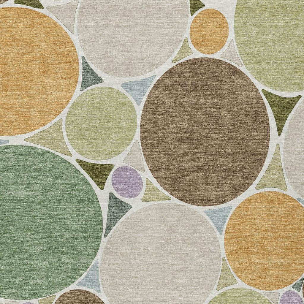 Geometric area rug close-up with green, brown, tan and white interlocking circles