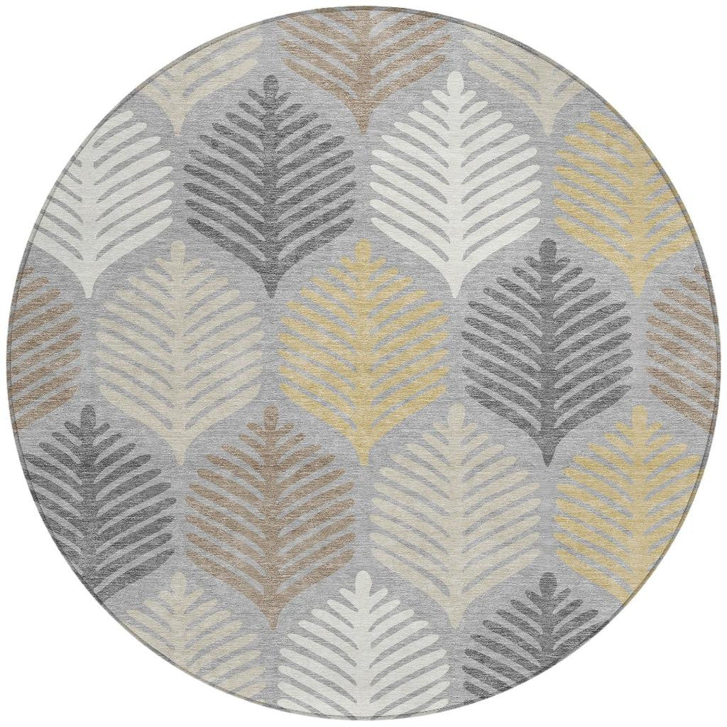 Top view of round gray area rug with repeating beige, cream, and light yellow leaf motifs.