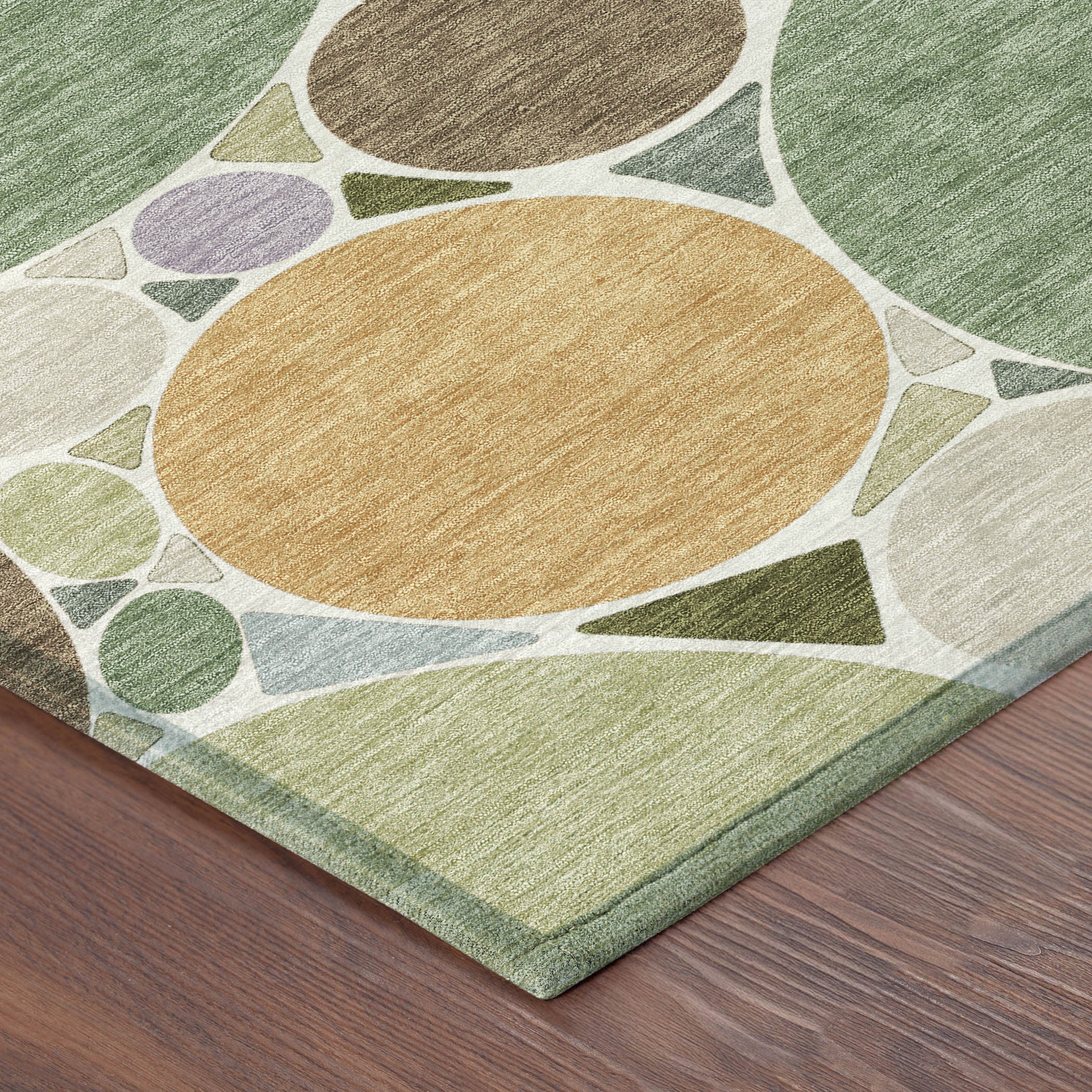 Geometric area rug corner with mustard tan, green and brown oval circle mosaic