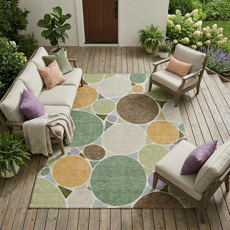Geometric area rug with layered circle pattern in green, tan, brown and purple accents
