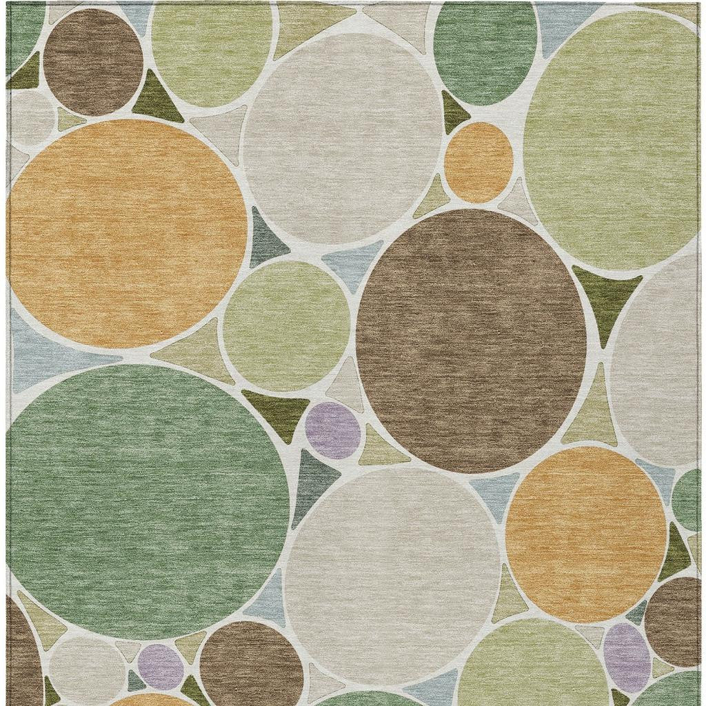 Geometric rectangular area rug with layered circles in green, tan, brown and white