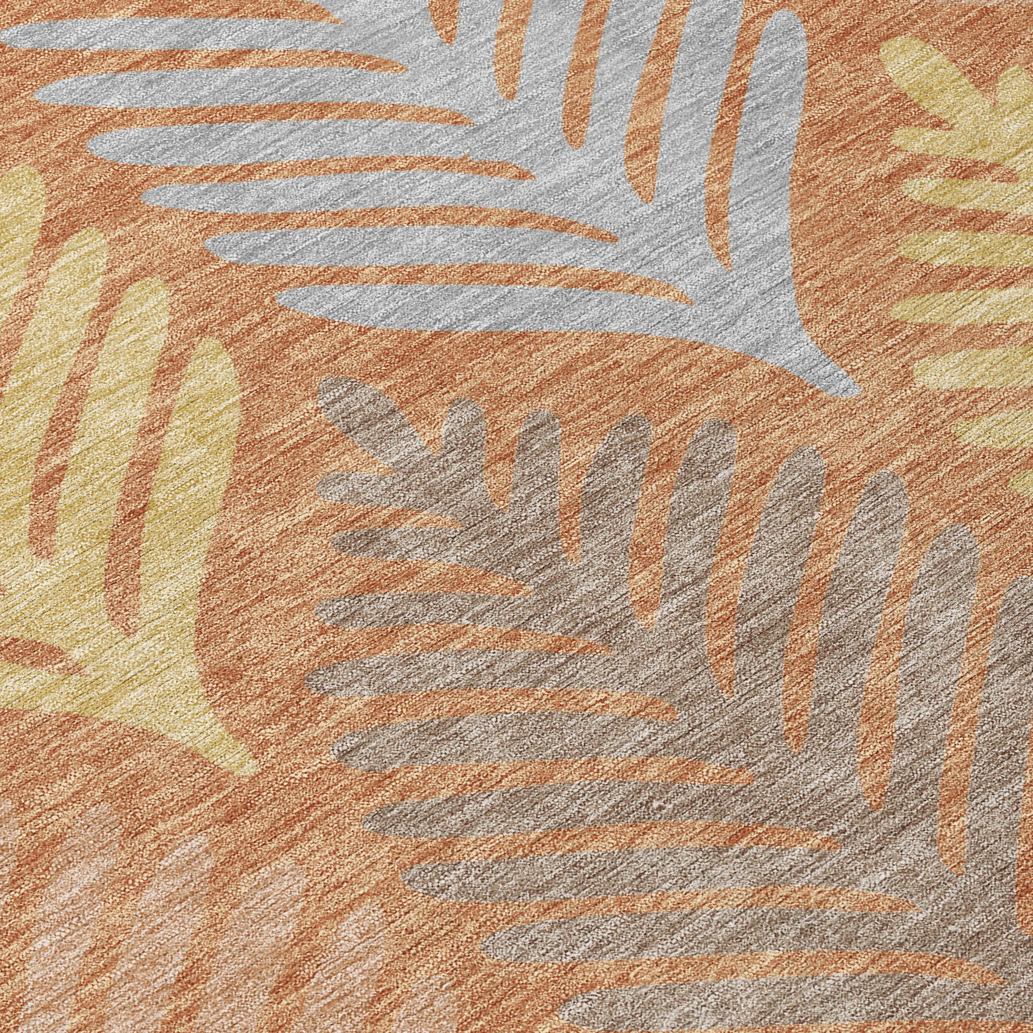 Close-up of orange and copper area rug with white and gray leaf pattern