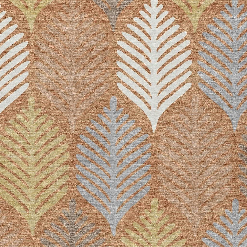 Close-up of leaf motifs on orange-copper rug with white and gray detailing
