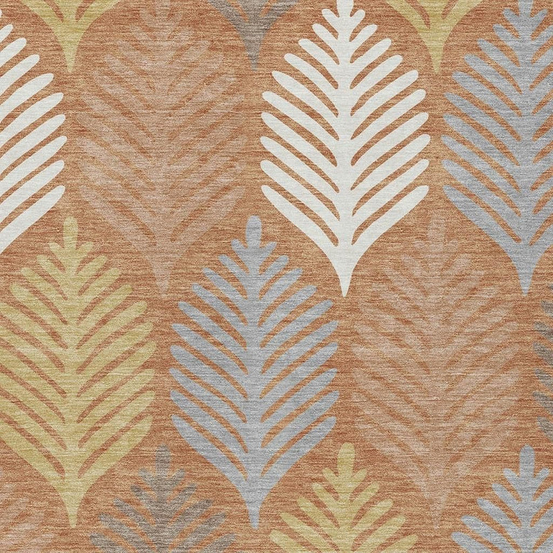 Close-up of leaf motifs on orange-copper rug with white and gray detailing