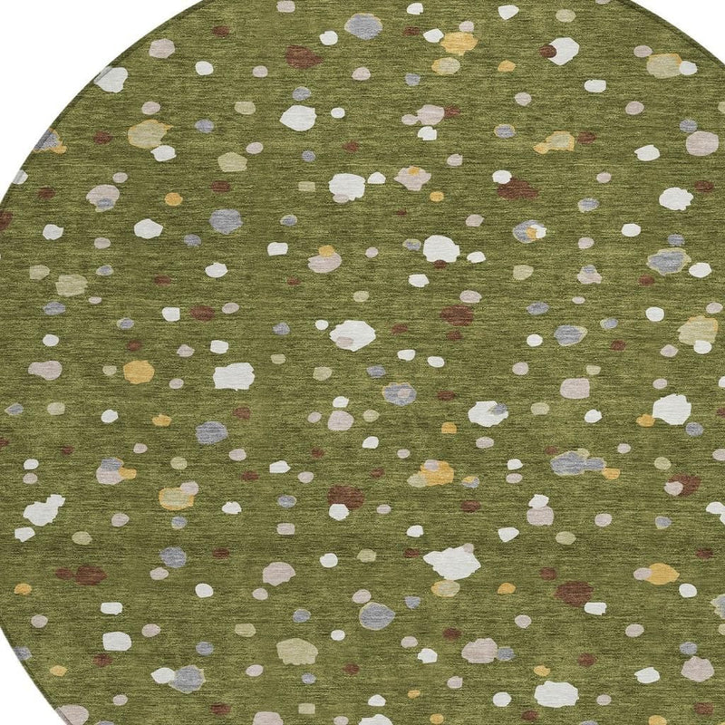 Close-up of olive green rug with off-white, gray, and small tan and red specks