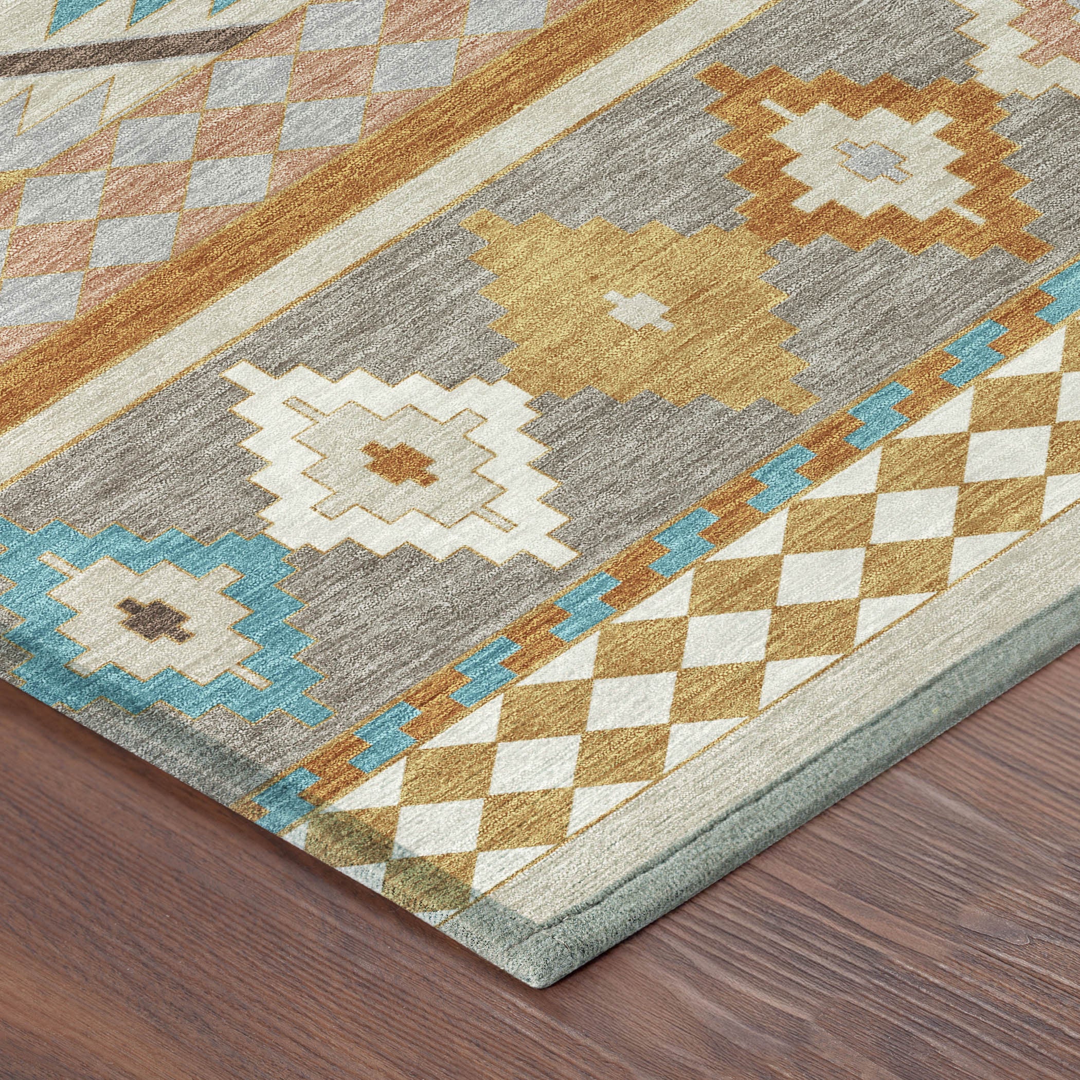 Corner view of southwestern area rug with gray, beige, orange, and blue geometric blocks