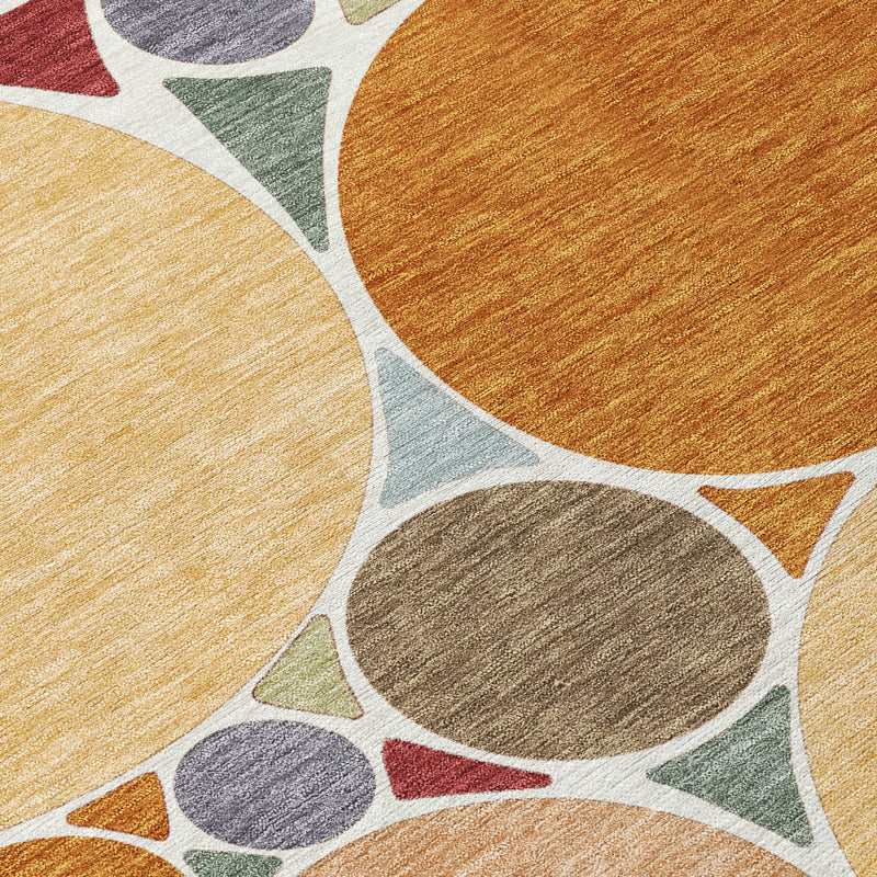 Closeup of geometric area rug fibers with orange, gold, and gray circle shapes