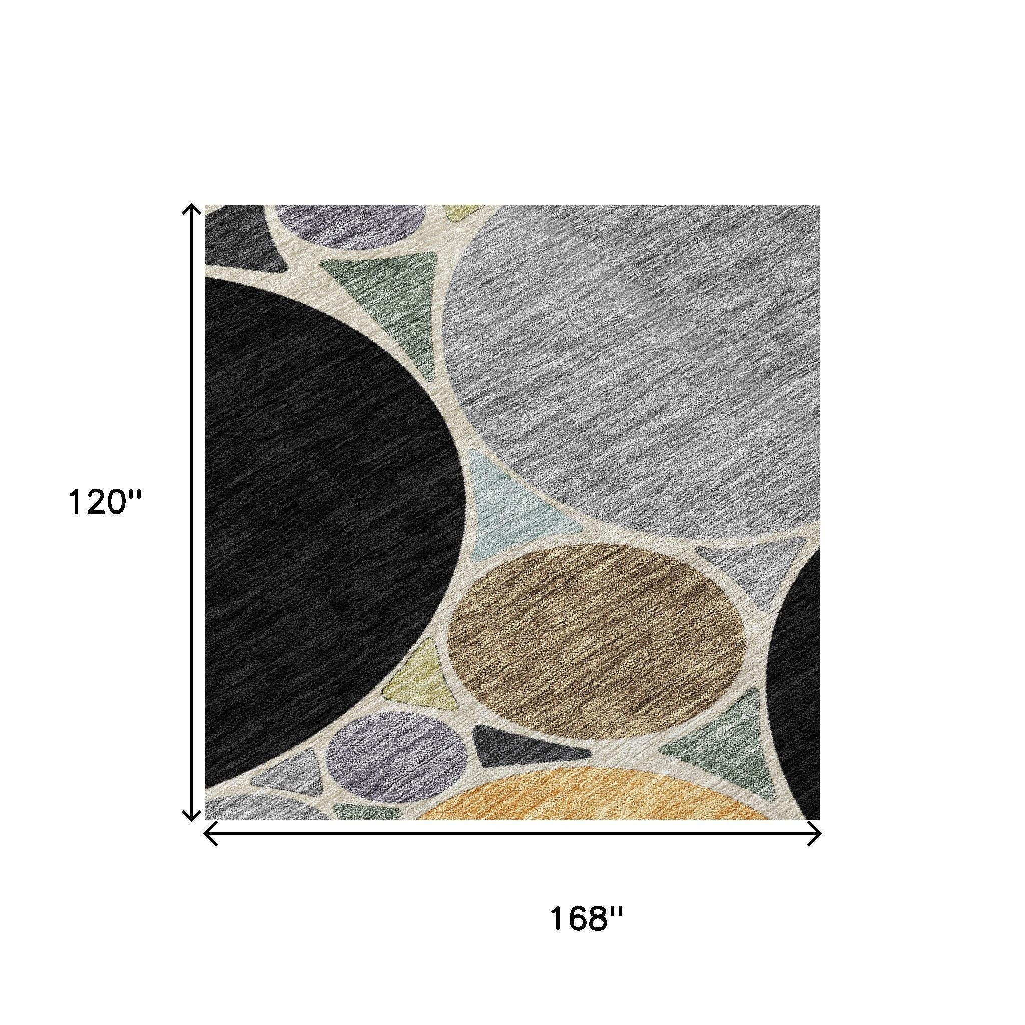 Geometric area rug with black, gray, and gold circular patterns on light background