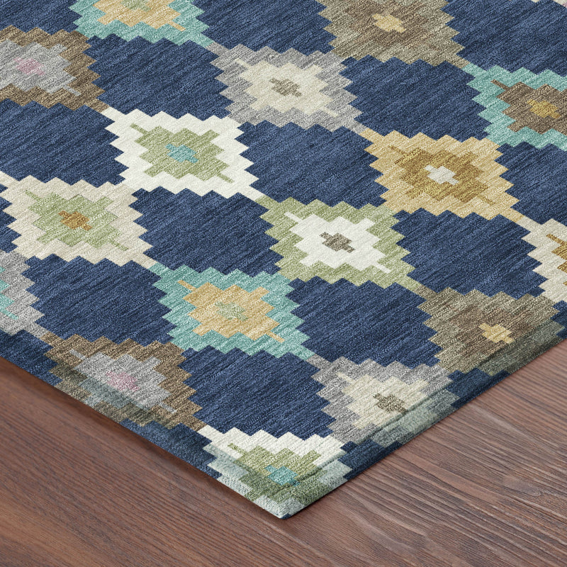 Geometric diamond area rug corner in navy blue, cream, teal, and tan