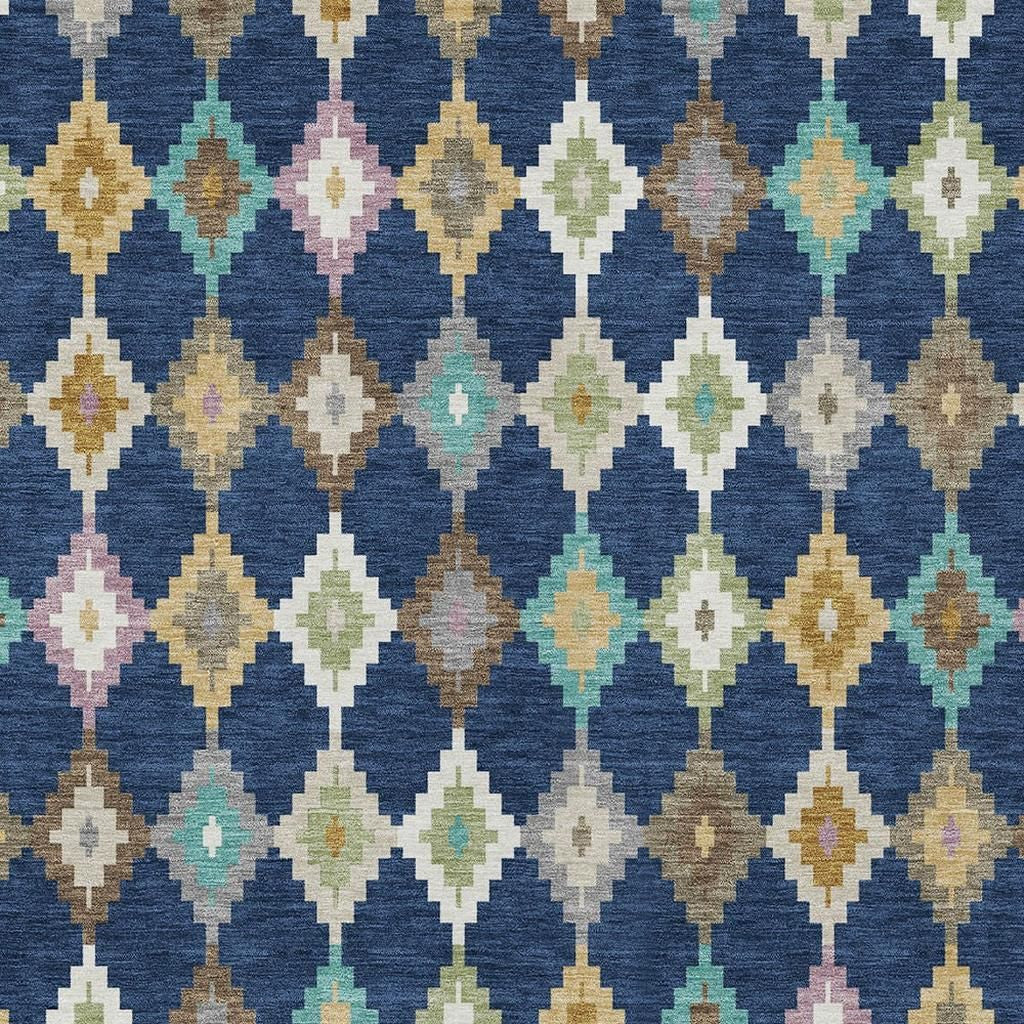 Close-up geometric diamond rug in navy blue with cream, tan, teal, and pink accents