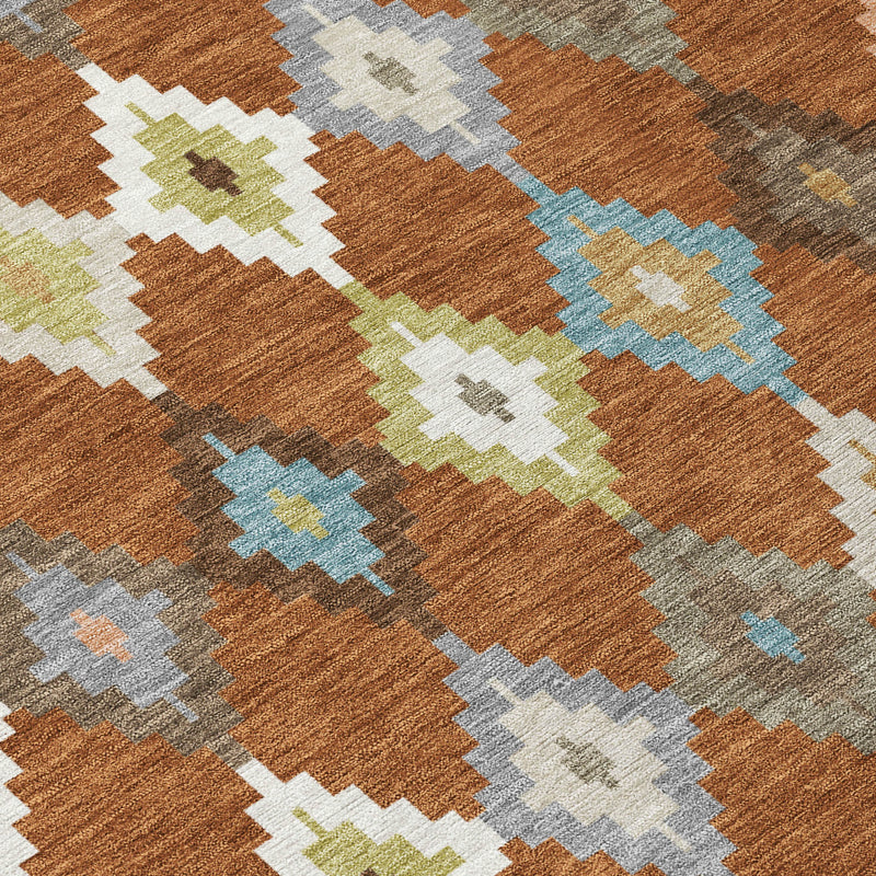 Orange-brown aztec rug with teal, gray, and lime cream diamond and zigzag motifs