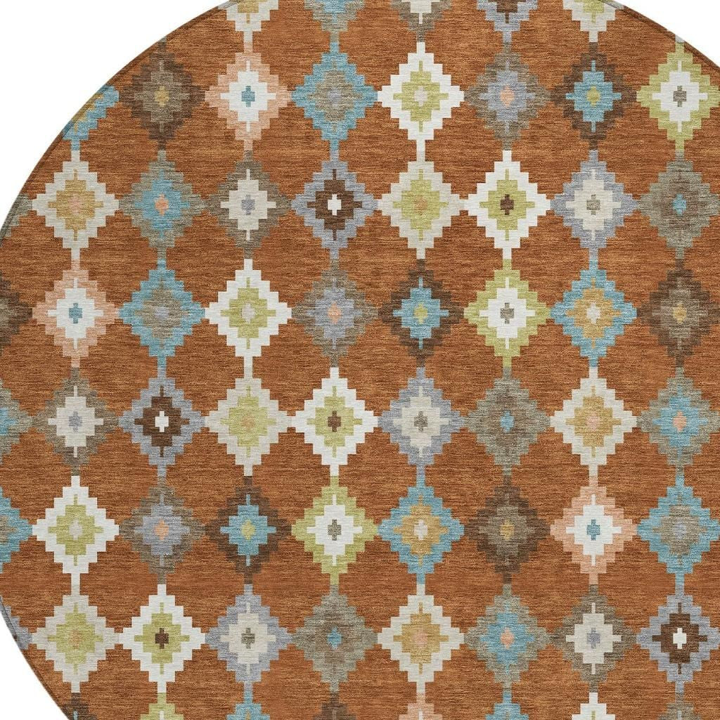 Aztec diamond pattern on orange-brown round rug with teal, gray, and cream accents