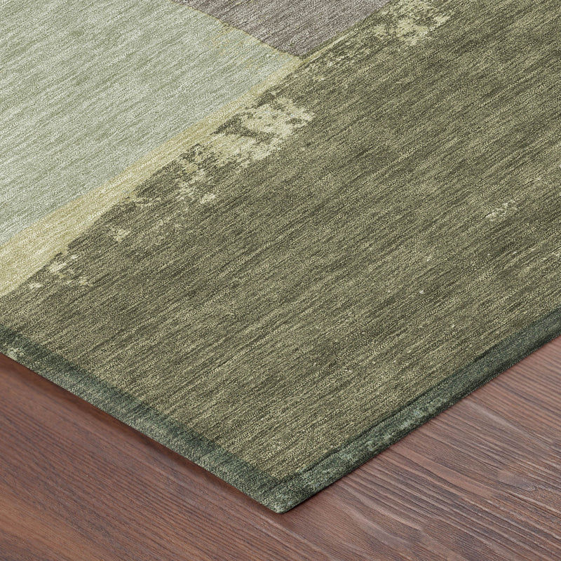 Close-up of geometric area rug texture in olive and fern green with gray sections