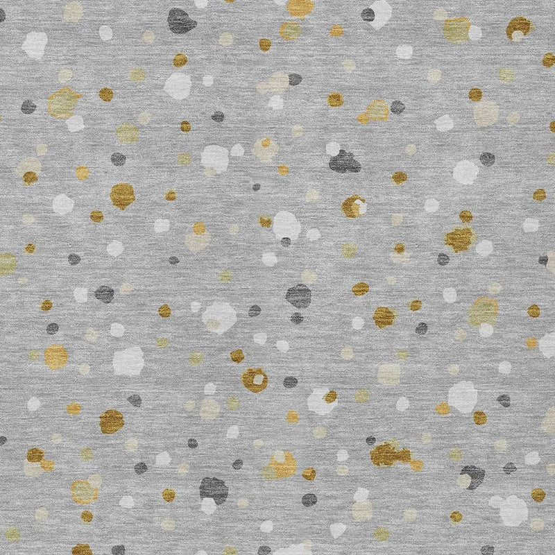 Close-up of gray geometric rug pattern with white, pale yellow, and dark speckled dots