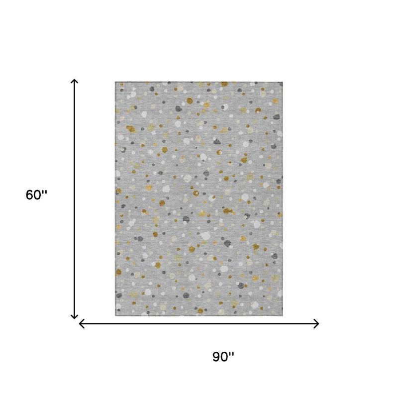 Gray geometric rug showing size 90 in x 60 in; scattered dot pattern with gold flecks