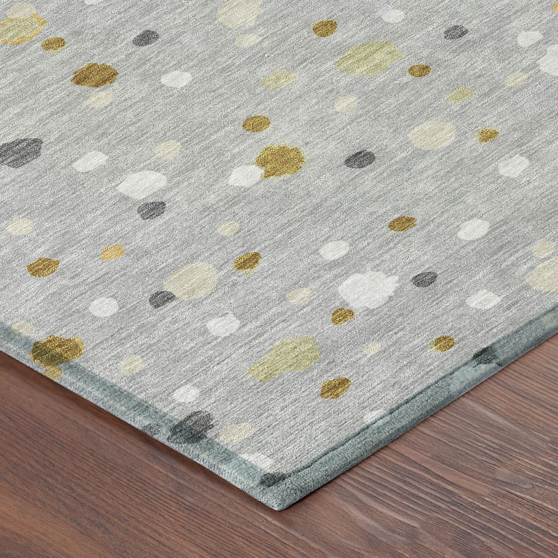Gray area rug corner view with scattered geometric dots in white, gold, and dark gray