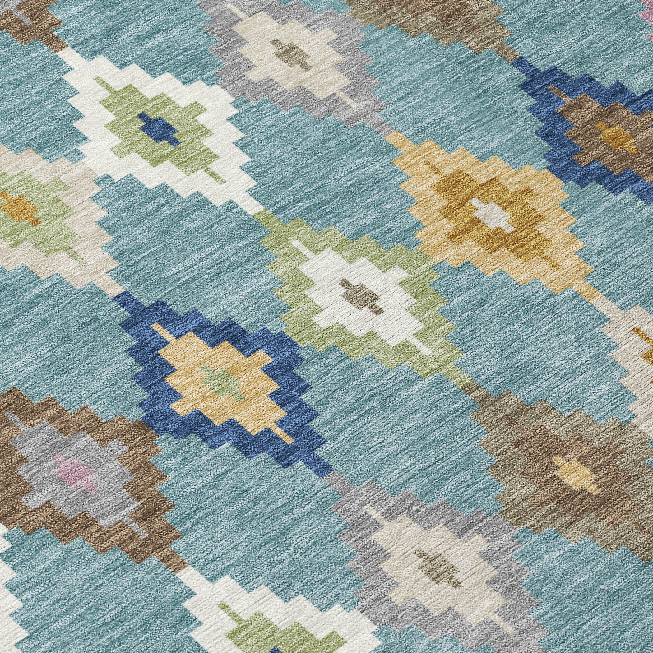 Teal blue rug fabric close-up with woven geometric diamond motifs